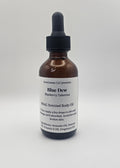 Bottle of Blue Dew body oil on a white background
