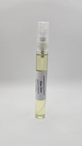 Small spray bottle with a white label on a light gray background