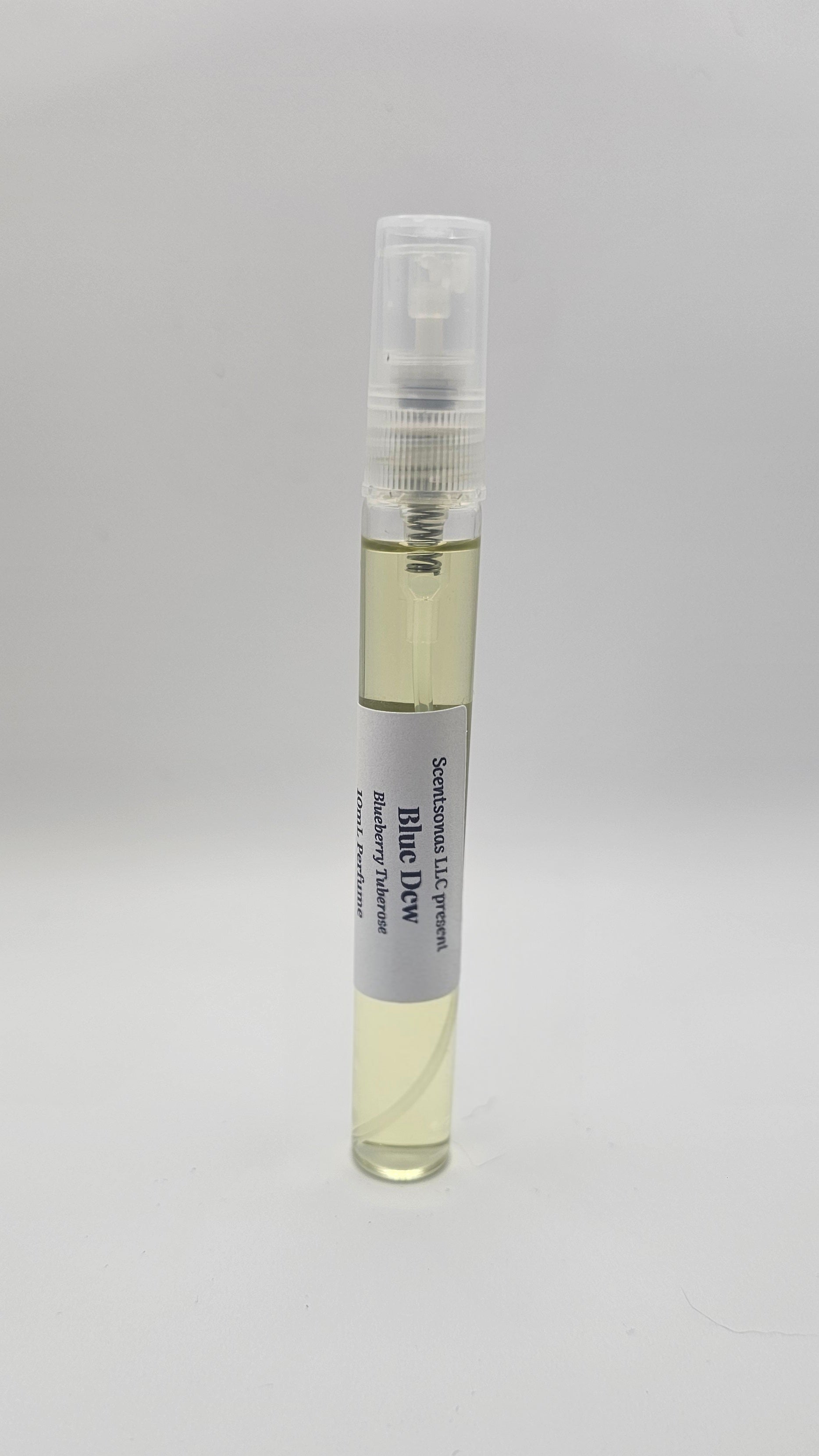 Small spray bottle with a white label on a light gray background