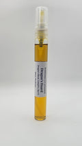 Small spray bottle with a yellow liquid on a white background
