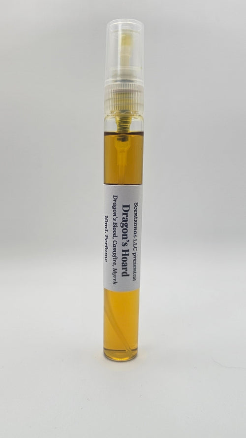 Small spray bottle with a yellow liquid on a white background