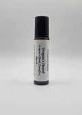 Roll-on bottle labeled 'Dragon's Hoard' with black cap on a light gray background