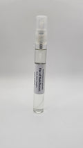 Small clear spray bottle with a label on a gray background