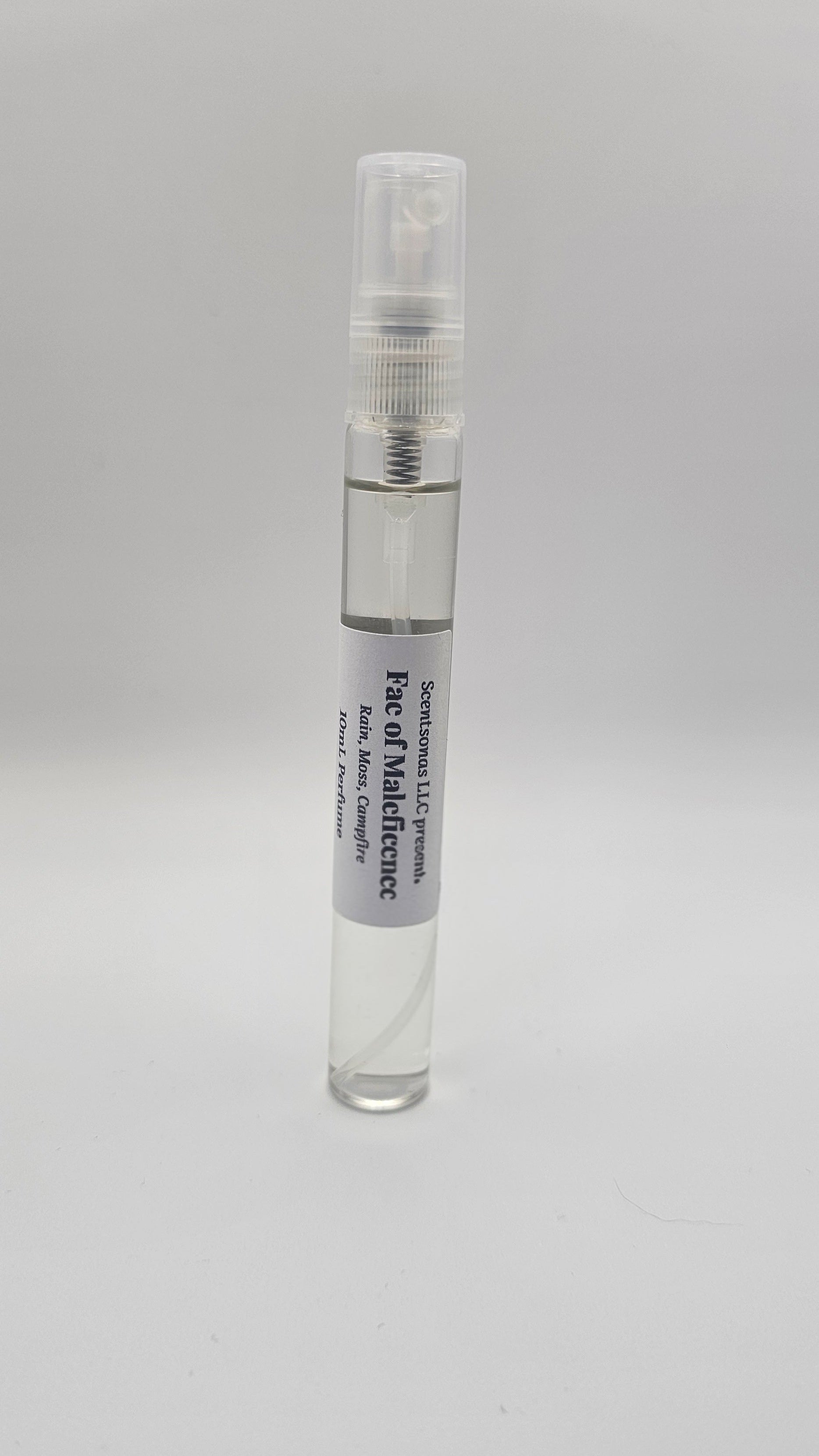 Small clear spray bottle with a label on a gray background
