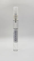 Small clear spray bottle with a label on a white background