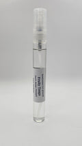 Small spray bottle with a gray label on a light gray background