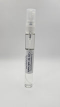 Small spray bottle with a label on a gray background