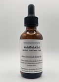 Bottle of Goldfish Girl body oil on a white background
