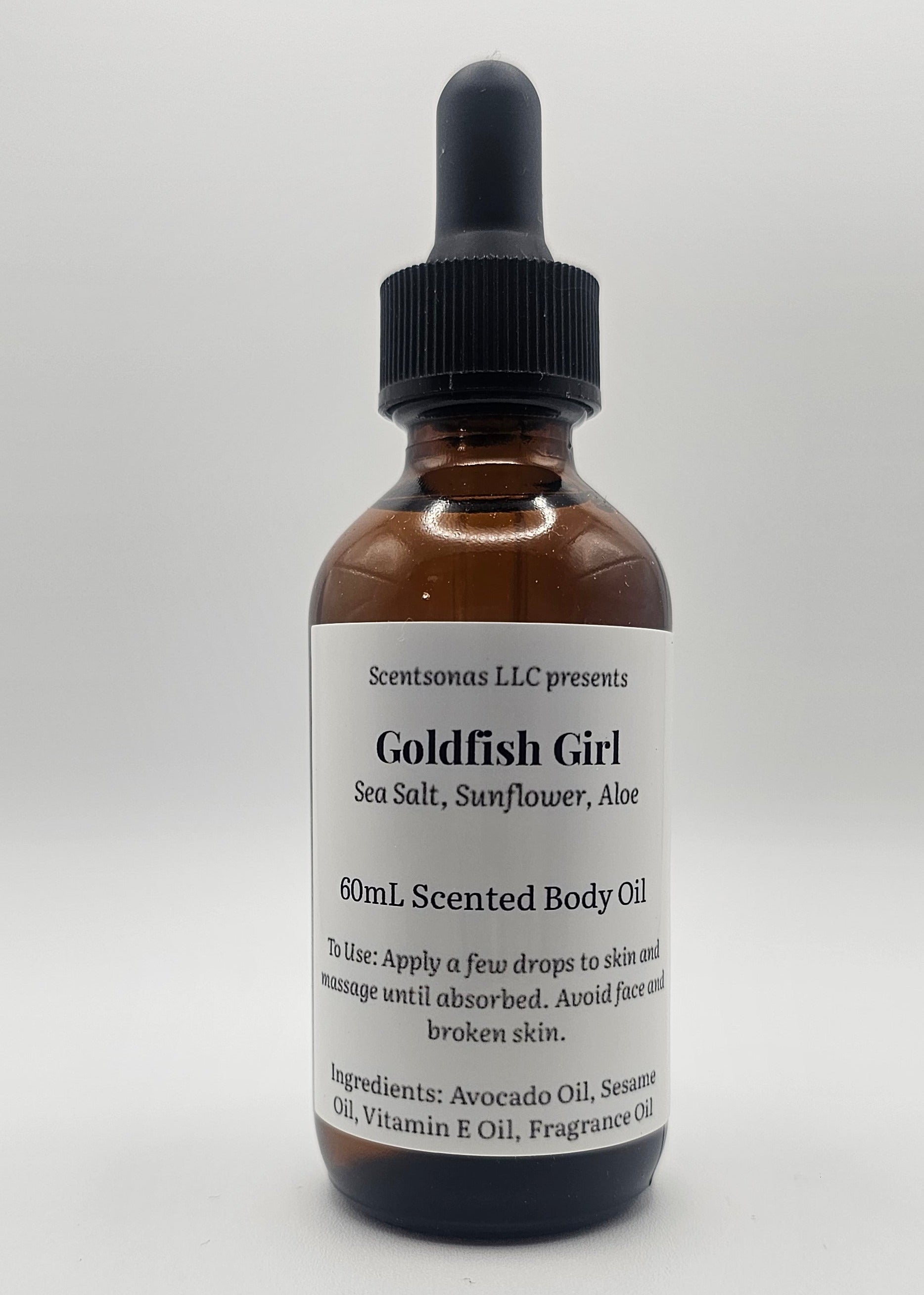 Bottle of Goldfish Girl body oil on a white background