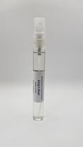 Small spray bottle with a label on a gray background
