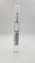 Small spray bottle with a label on a gray background