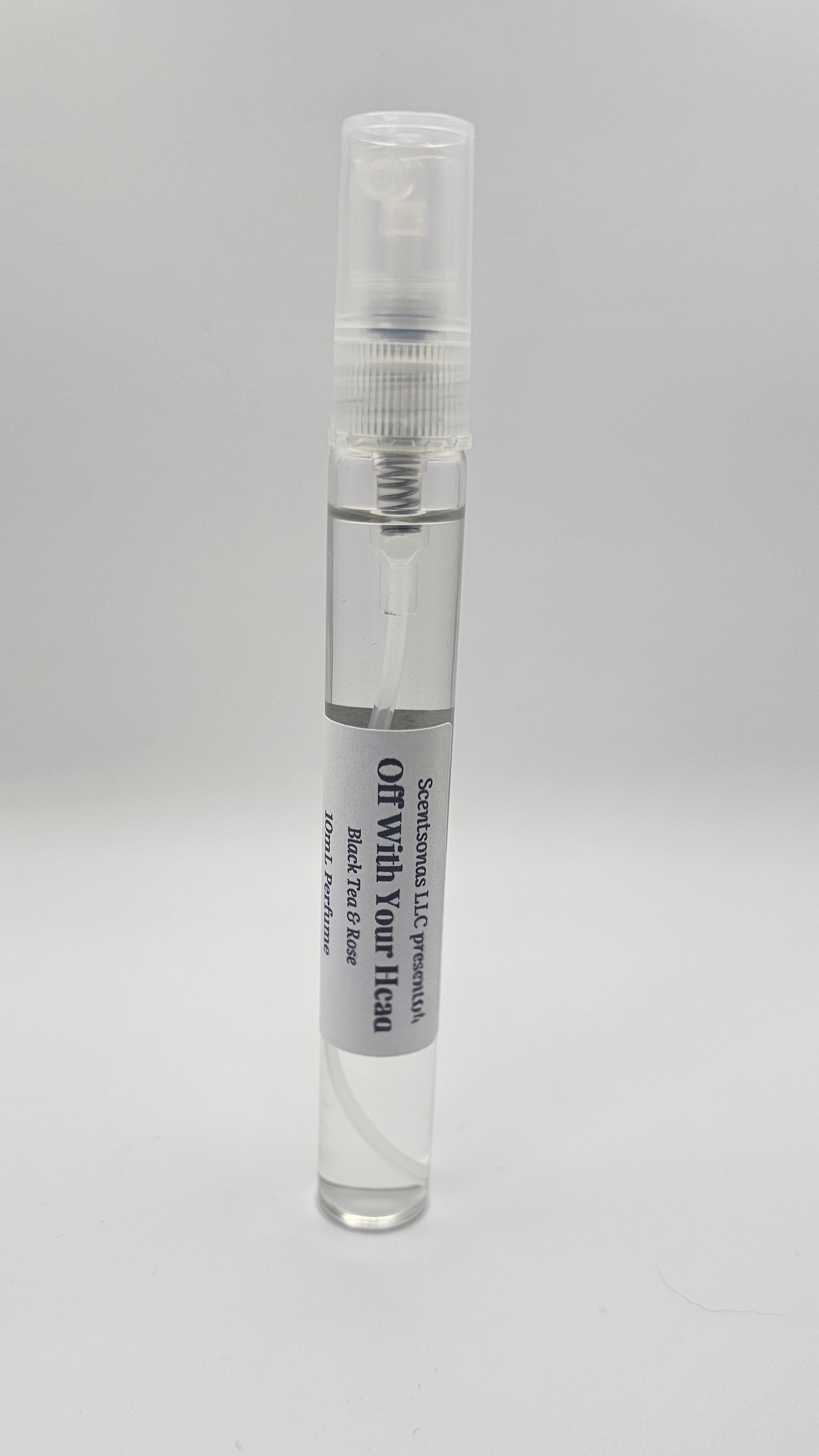 Small spray bottle with a label on a gray background
