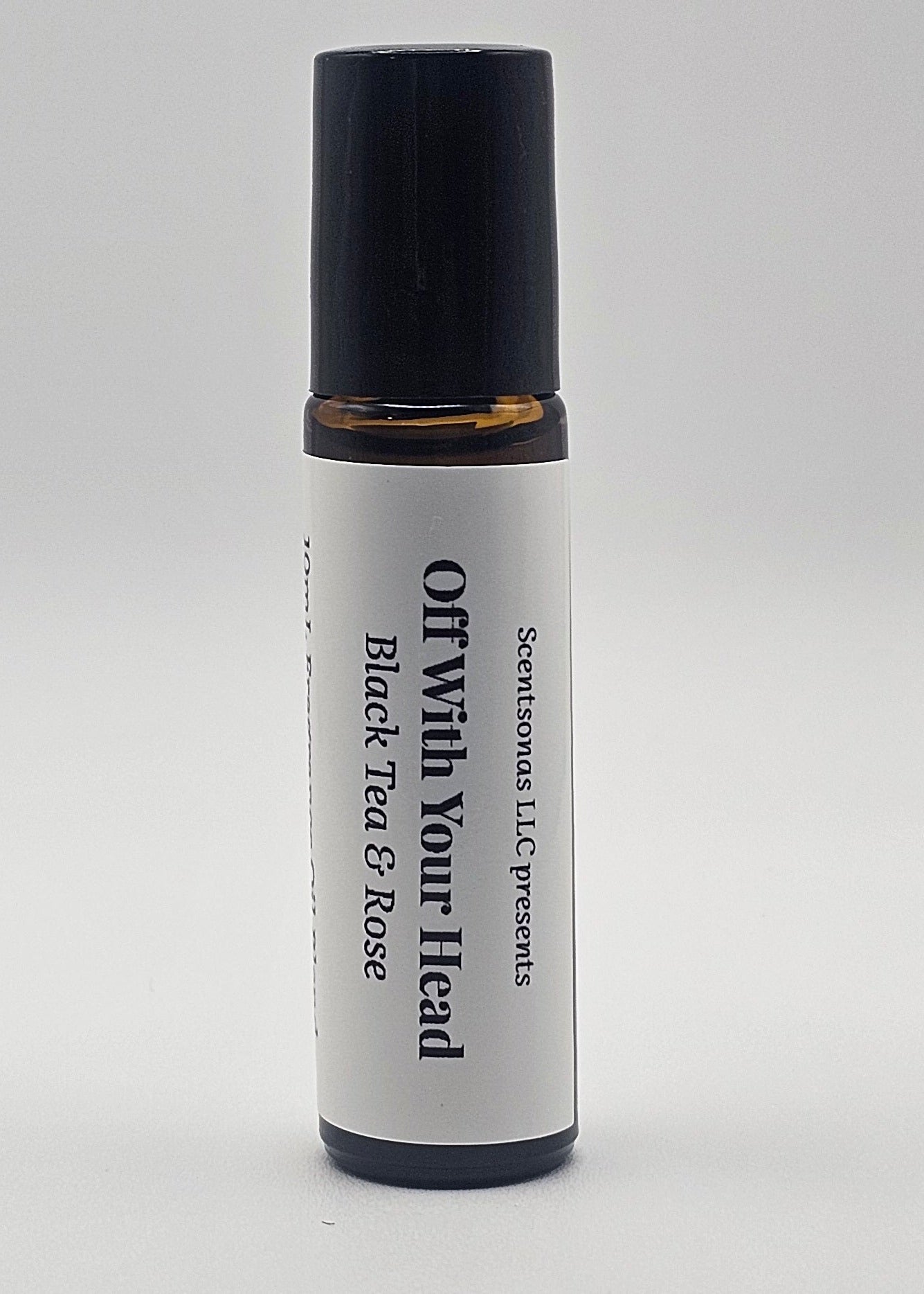 Roll-on bottle with black cap and white label on a light gray background