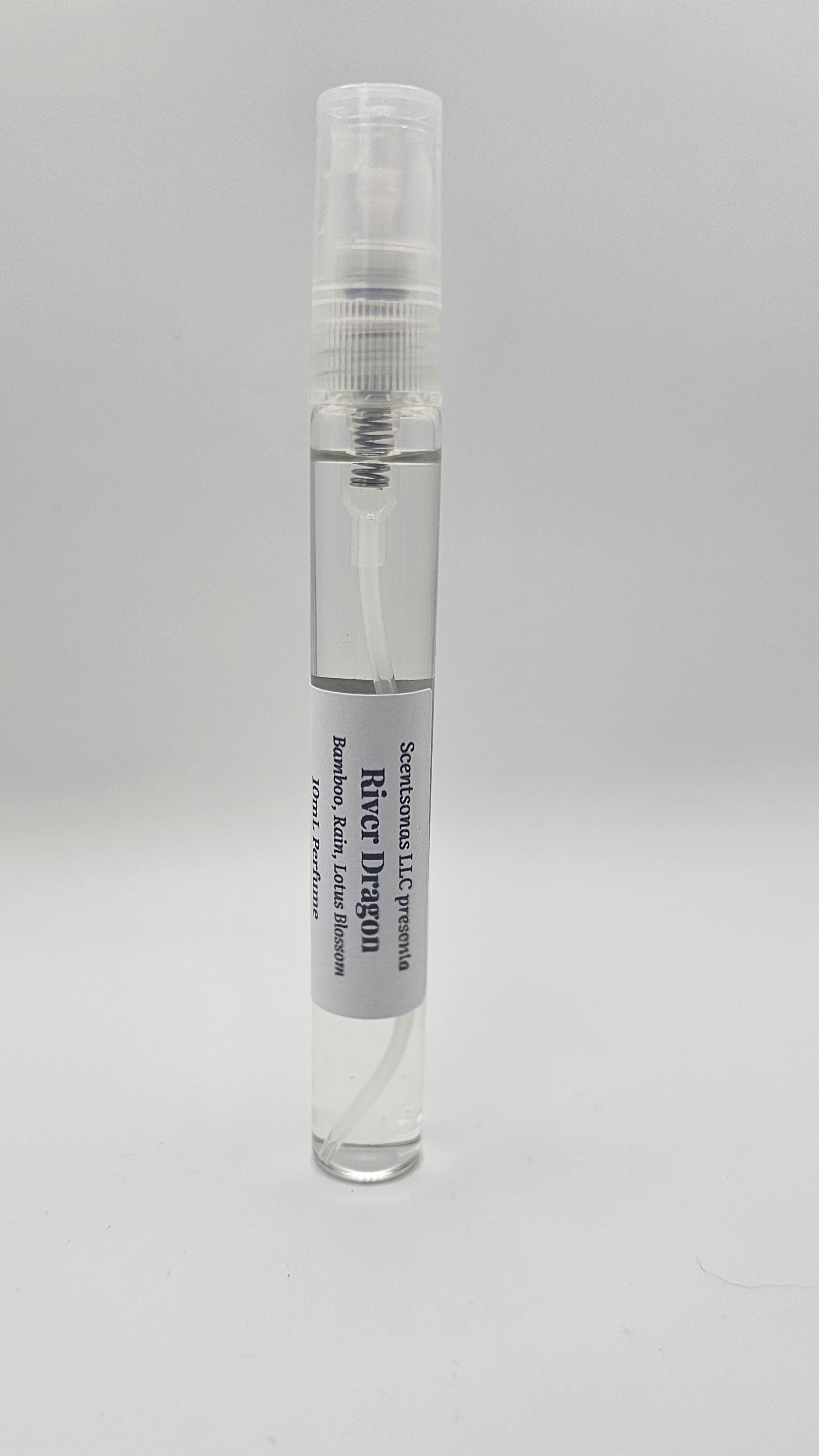 Small clear glass bottle with a white cap on a gray background