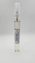 Small spray bottle with a gray label on a light gray background
