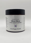 Jar of Silver Sleep sugar scrub with a black lid on a white background