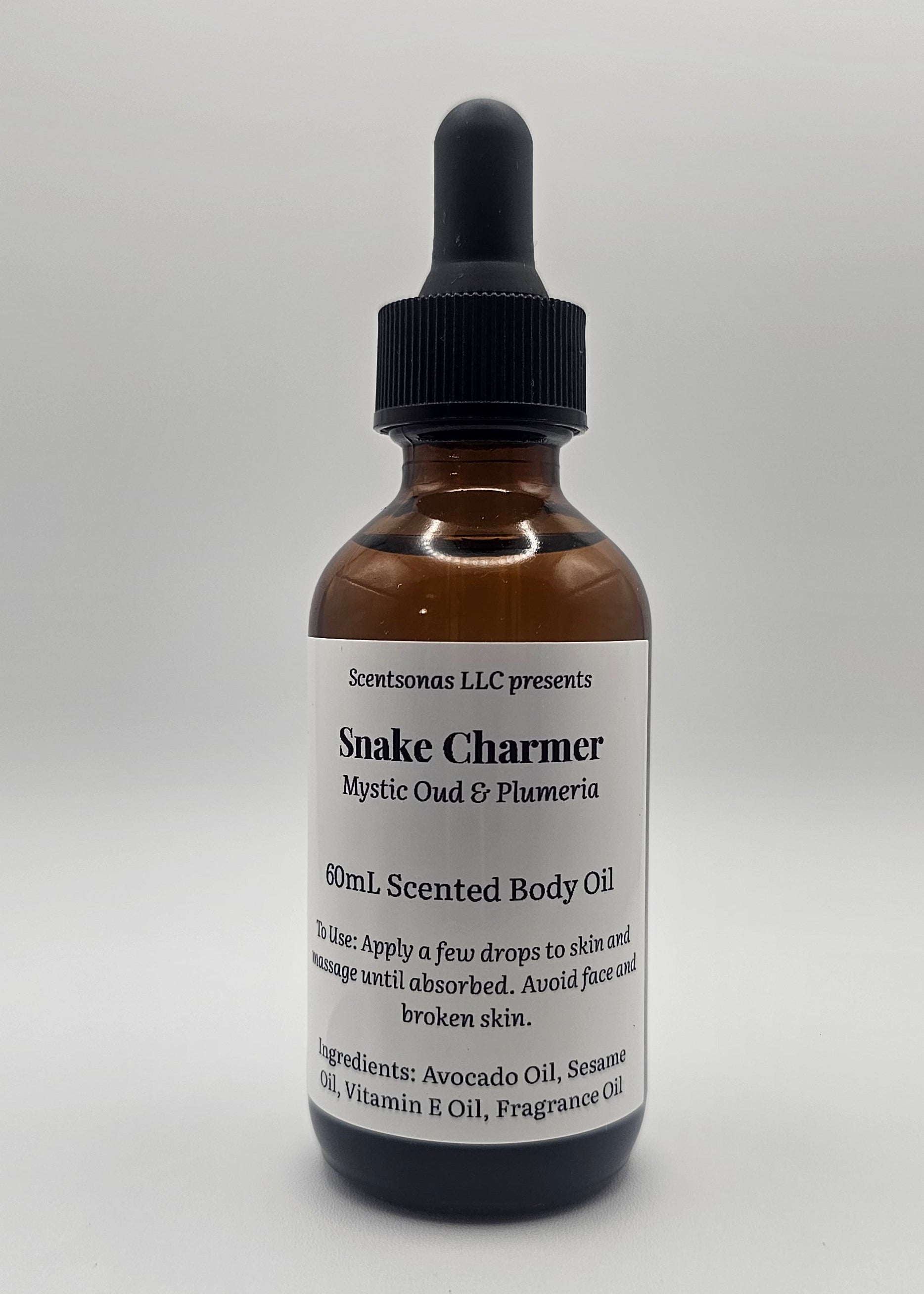 Bottle of Snake Charmer oil with a label on a white background