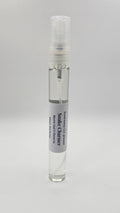 Small spray bottle with a label on a gray background