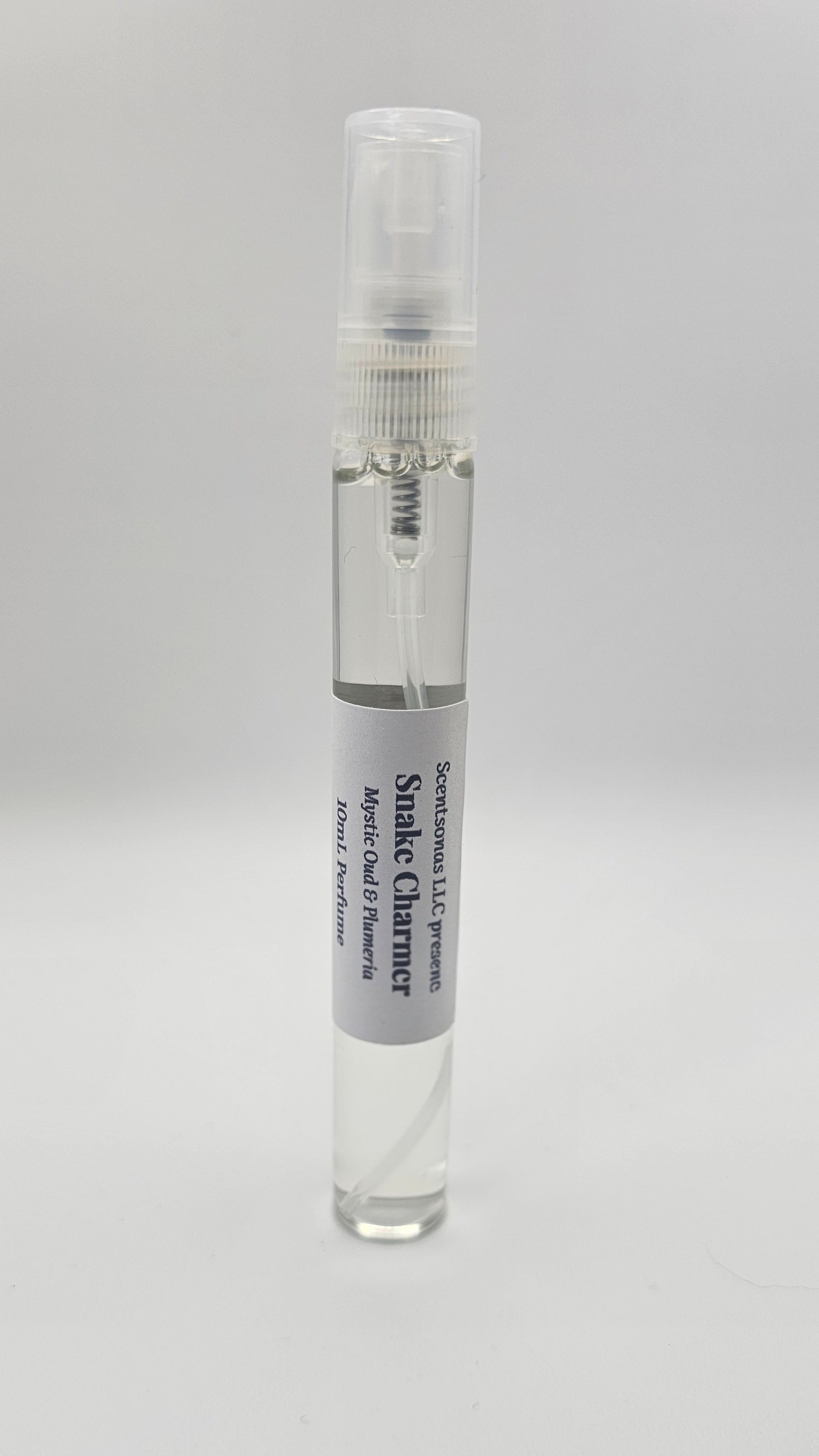 Small spray bottle with a label on a gray background