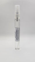 Small spray bottle with a label on a gray background