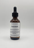 Bottle of Unscented body oil on a light gray background