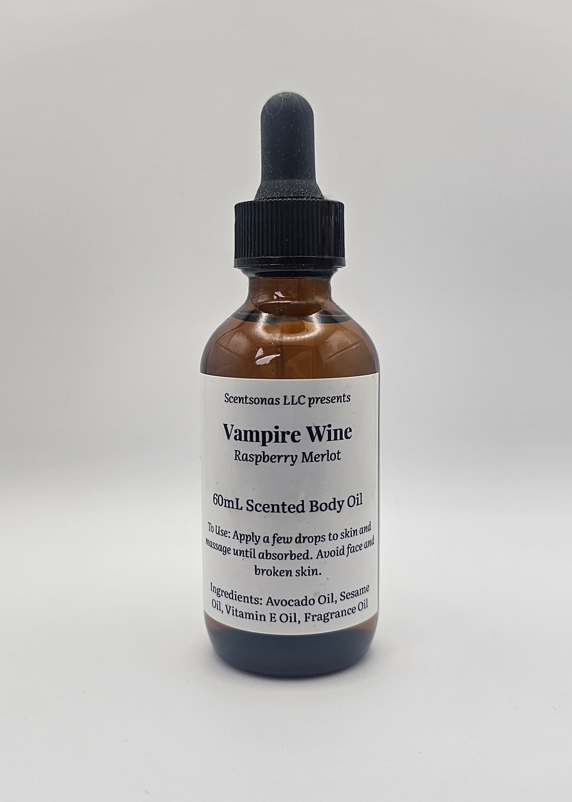 Bottle of Vampire Wine Raspberry Merlot body oil on a white background
