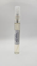 Small glass bottle with a gray label on a light gray background