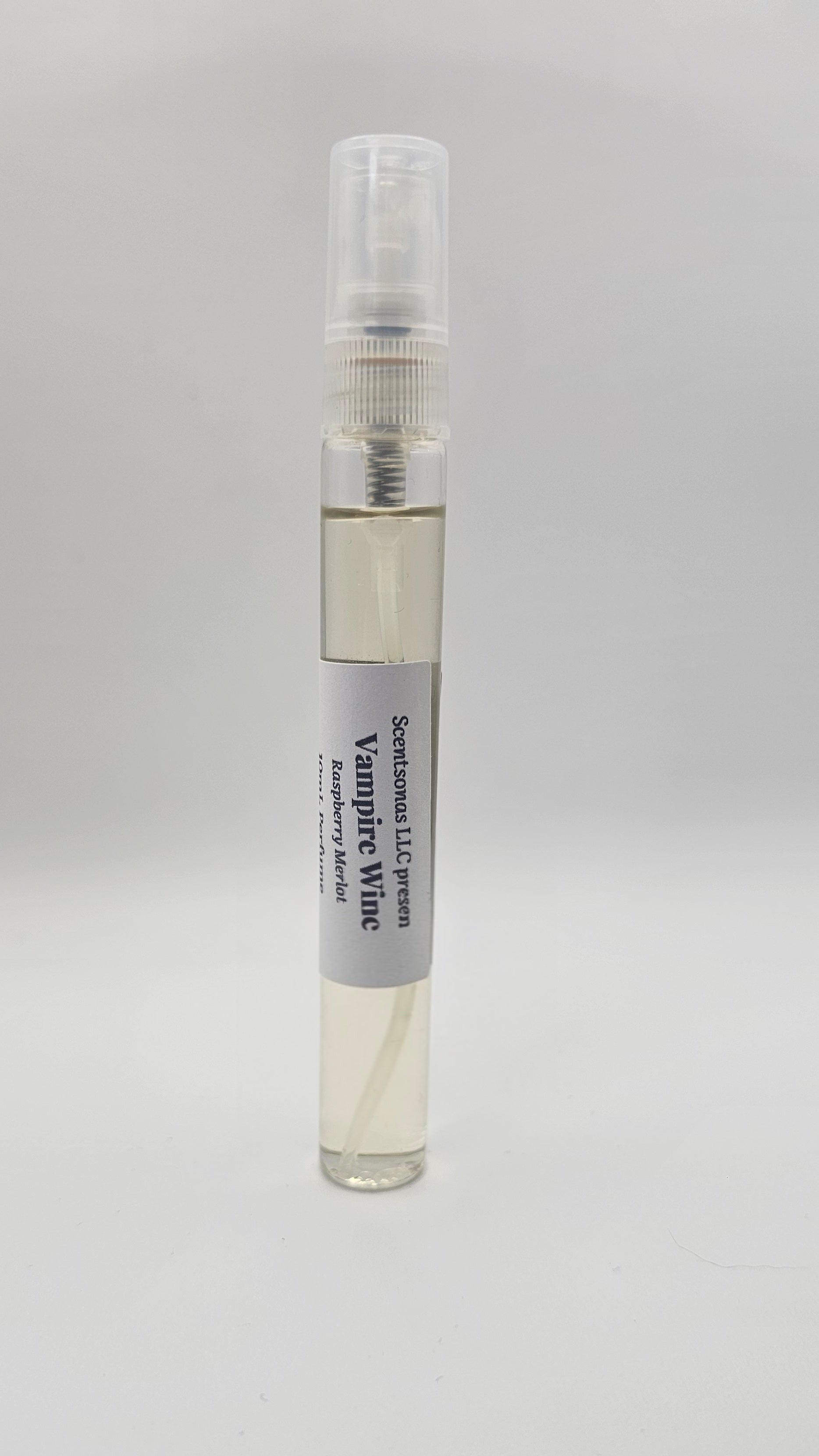 Small glass bottle with a gray label on a light gray background