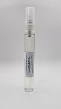 Small clear spray bottle with a label on a gray background
