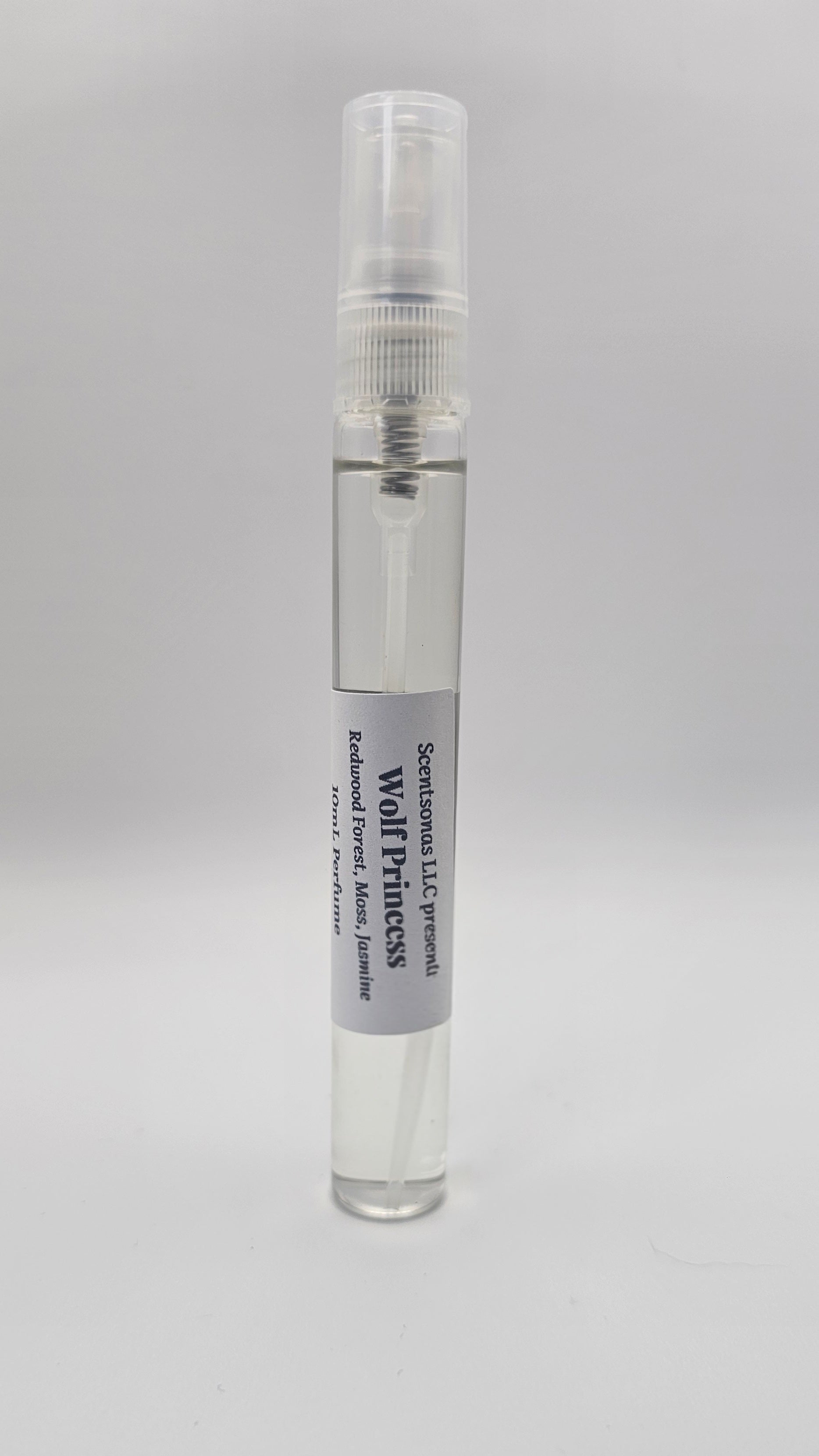 Small clear spray bottle with a label on a gray background